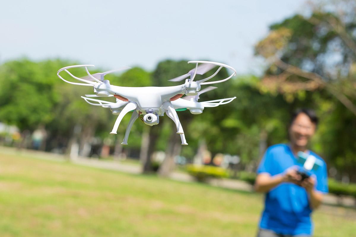 student flying drone